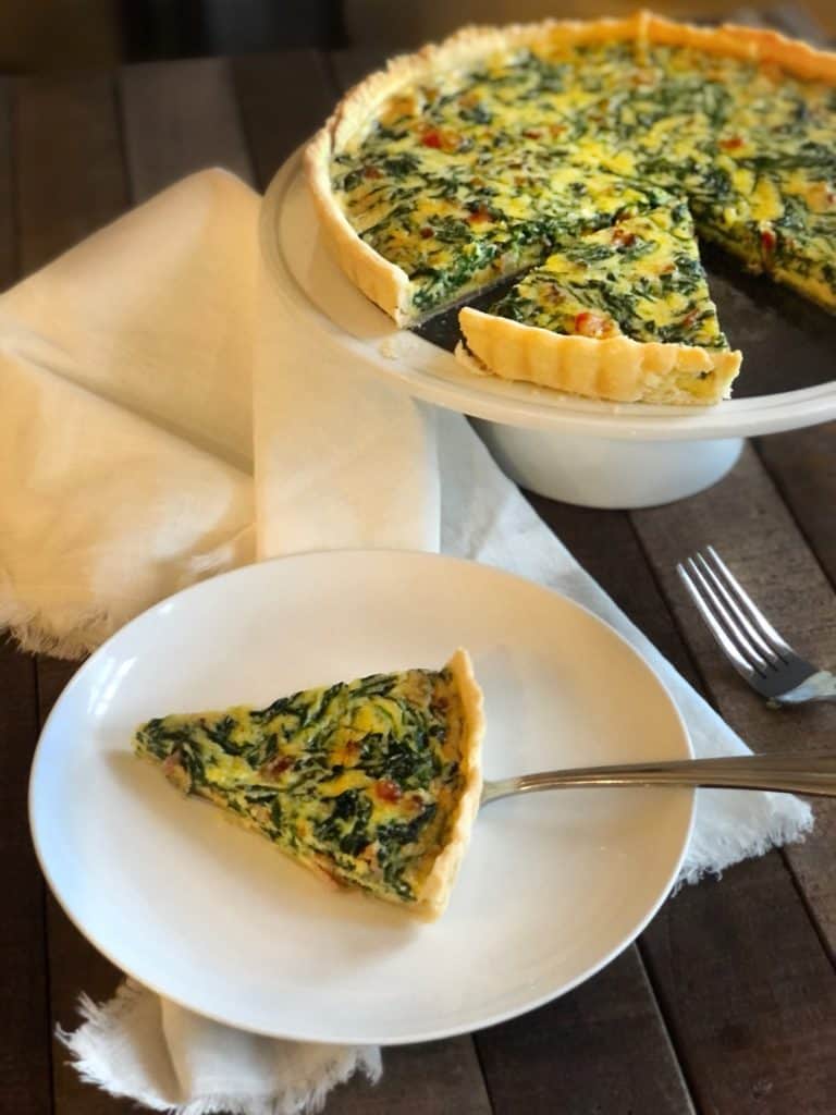 Quiche sitting on a wood table.