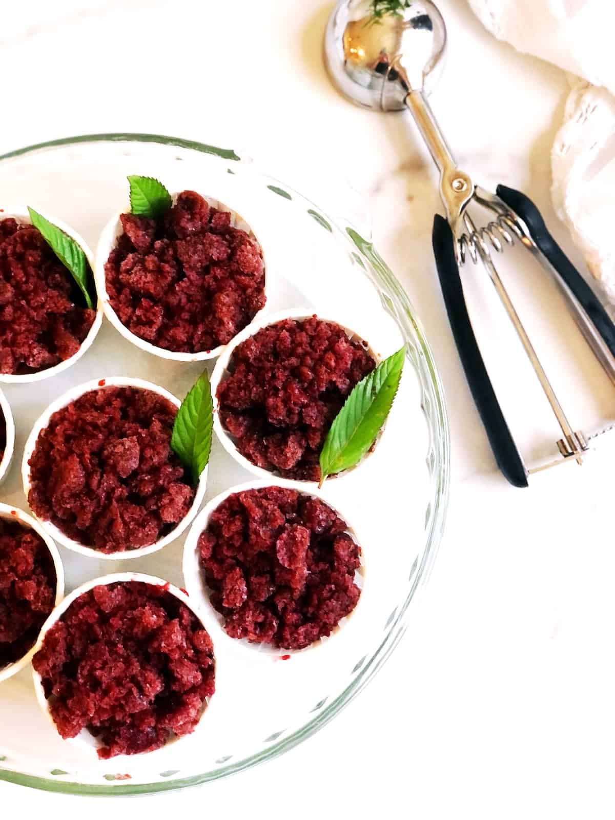 A plate of cherry granita on a white plate.