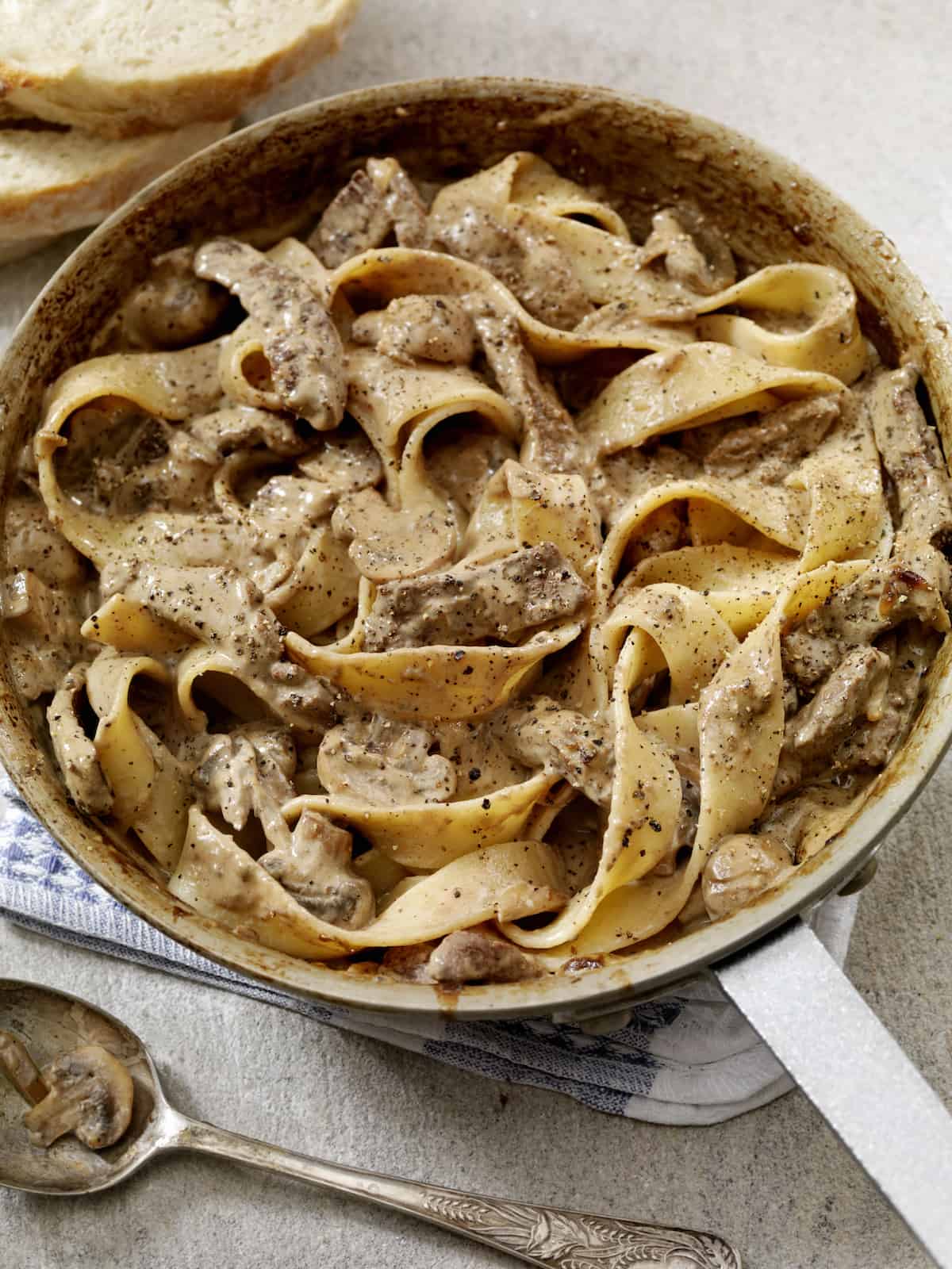 A pan full of pasta with prime rib in it.