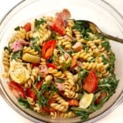 Tuna pasta salad recipe in glass bowl with a spoon