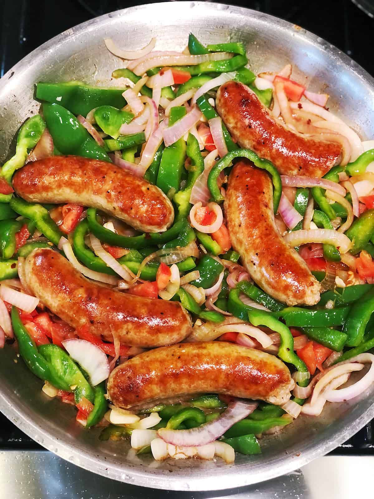 Italian sausage and peppers in a pan.