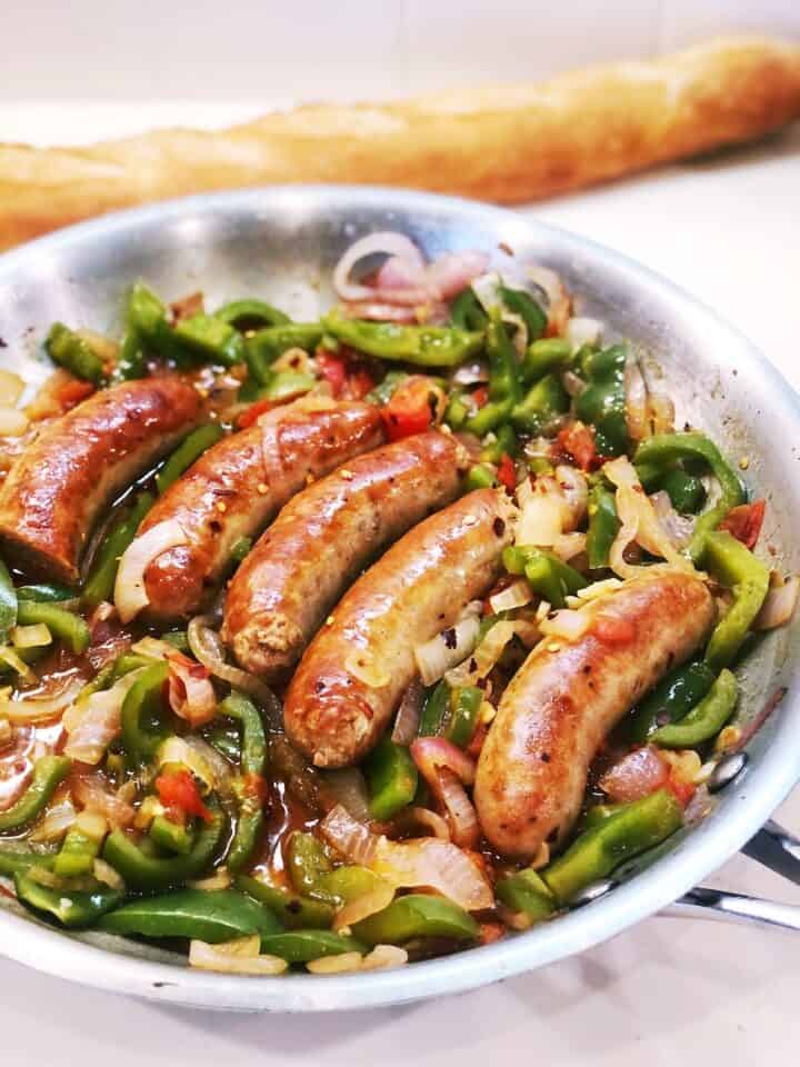 Italian sausage and peppers in a pan closeup.