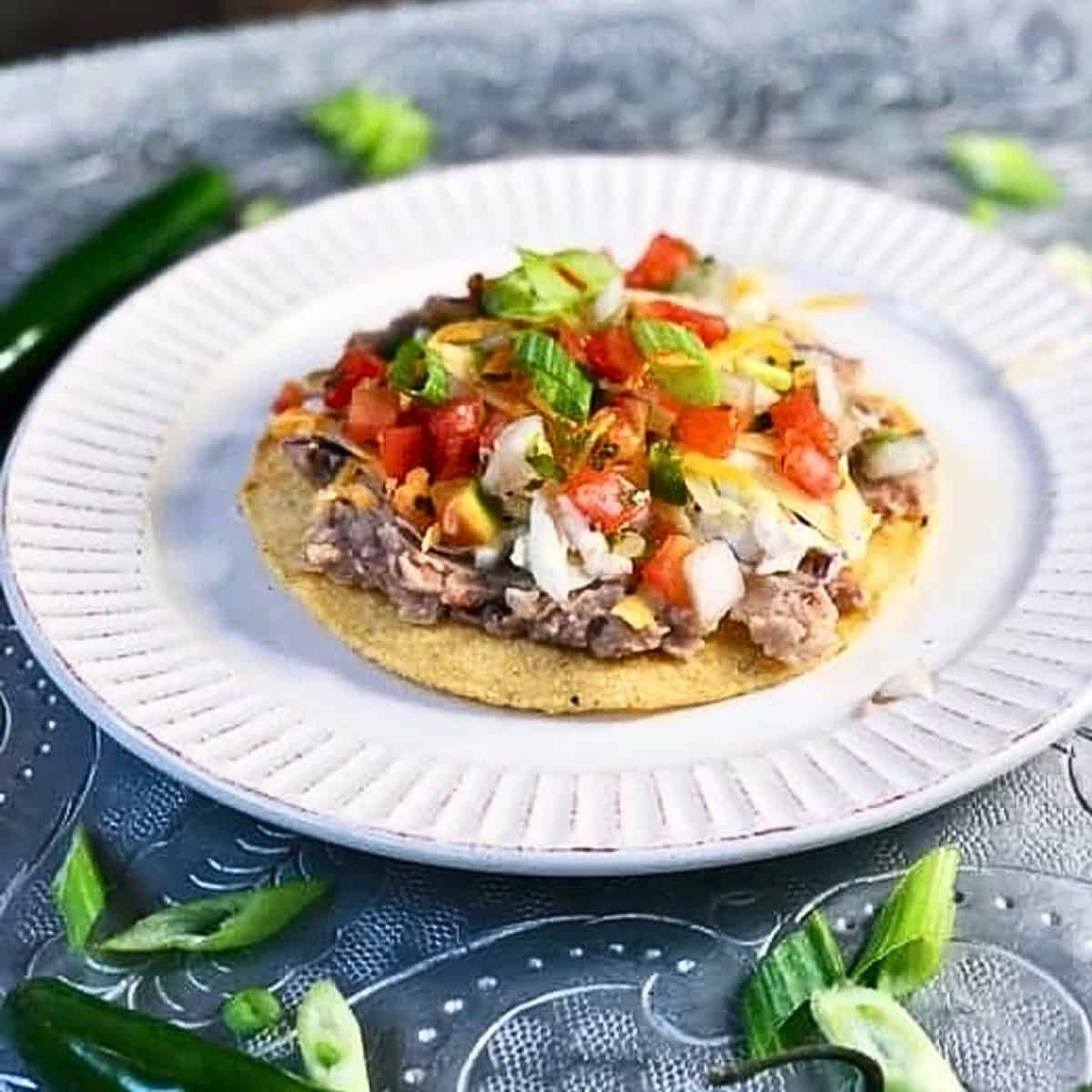Refried bean tostadas on a plate.